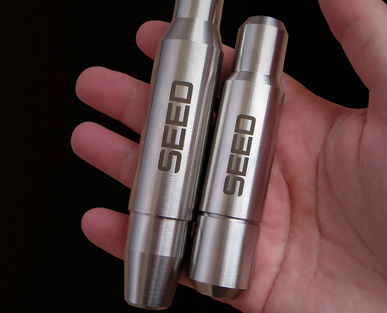 SEED and SEED2 tattoo machines in hand